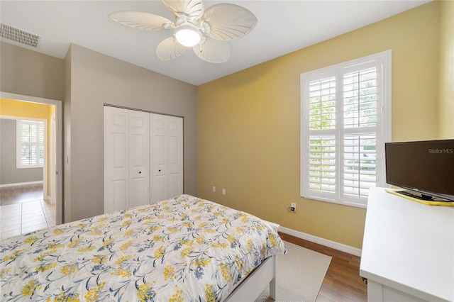 bedroom featuring a closet, hardwood / wood-style flooring, and ceiling fan