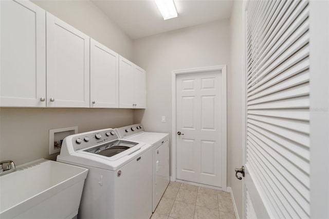 laundry room featuring washer and dryer, sink, light tile patterned floors, and cabinets