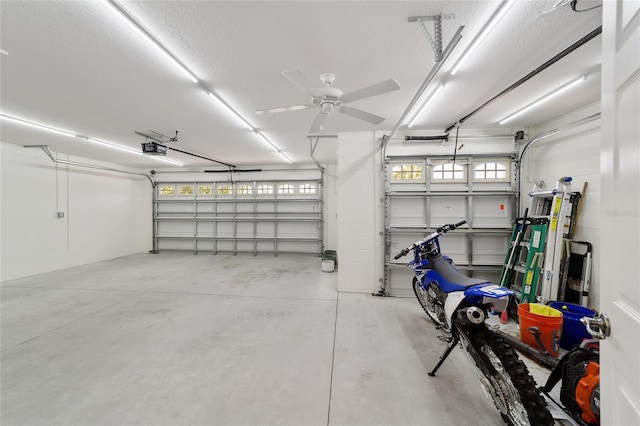 garage featuring a garage door opener and ceiling fan