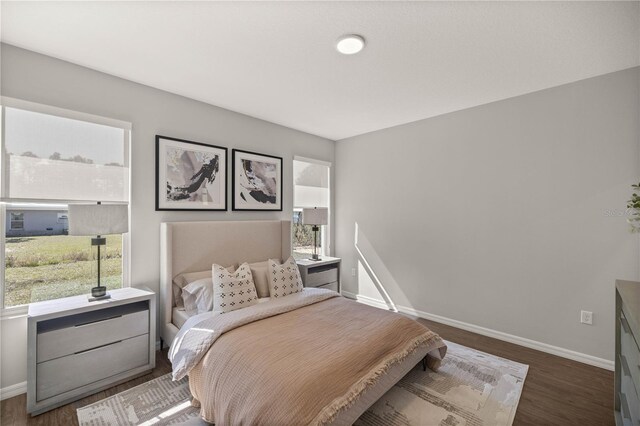 bedroom with dark hardwood / wood-style floors