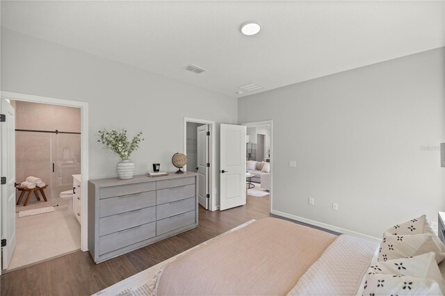 bedroom with light wood-type flooring and connected bathroom