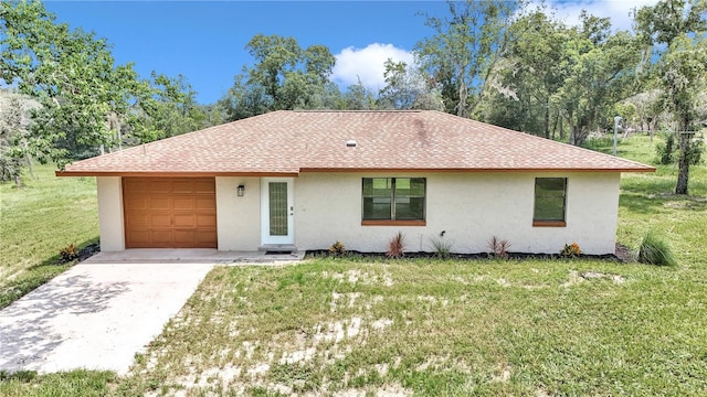 ranch-style home with a garage and a front lawn