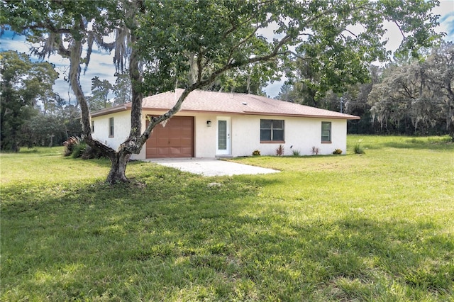 view of front of house featuring a garage and a front lawn