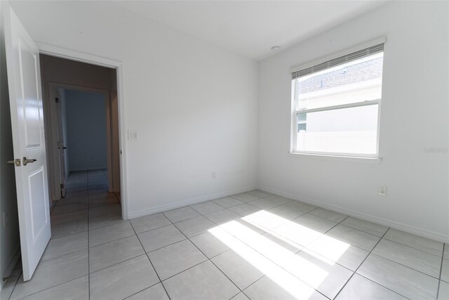 unfurnished room featuring light tile patterned floors