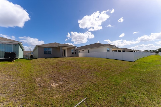 rear view of house with a lawn