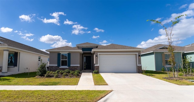 view of front of house with a front yard and a garage