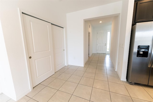 hall with light tile patterned floors