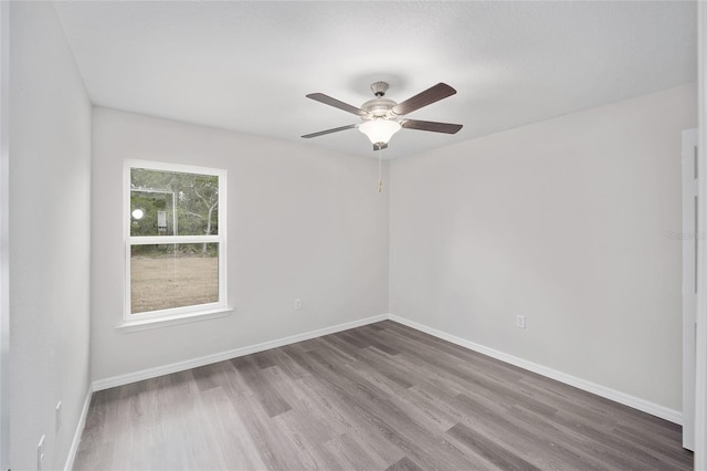 unfurnished room with ceiling fan and hardwood / wood-style flooring