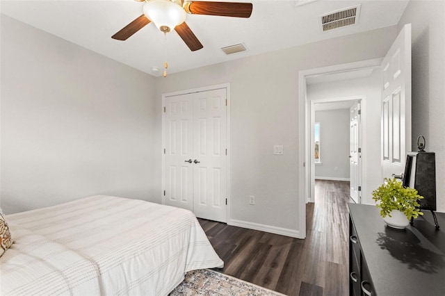 bedroom featuring ceiling fan, a closet, and dark wood-type flooring