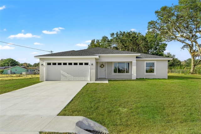 view of front of property with a garage and a front lawn