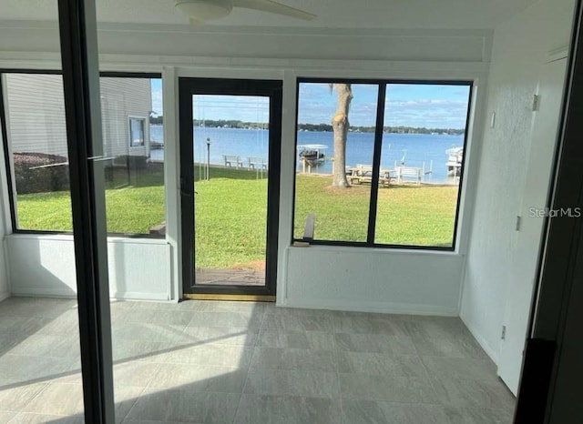 doorway featuring a water view and a wealth of natural light