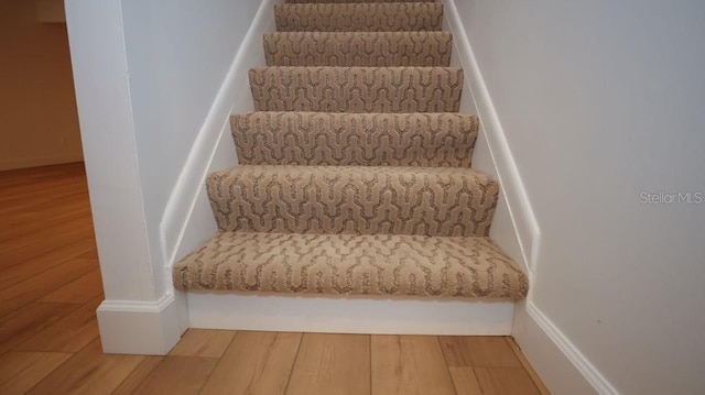 stairs with hardwood / wood-style flooring