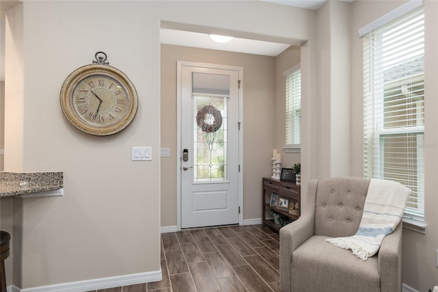 entryway with dark hardwood / wood-style flooring and plenty of natural light