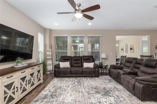 living room with dark hardwood / wood-style flooring and ceiling fan