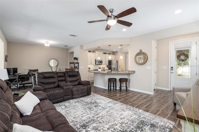 living room featuring ceiling fan and dark wood-type flooring