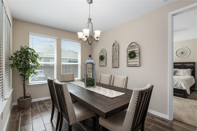 dining space with a chandelier and dark wood-type flooring