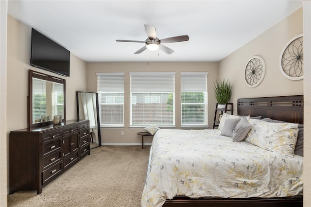 bedroom with ceiling fan and light colored carpet