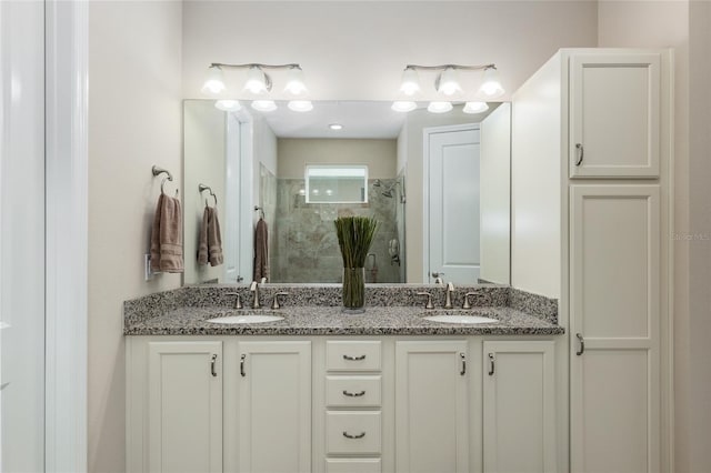 bathroom with vanity and a shower with shower door