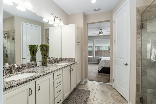 bathroom featuring tile patterned flooring, vanity, ceiling fan, and an enclosed shower