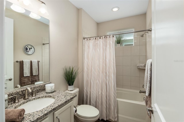 full bathroom featuring shower / bath combination with curtain, vanity, and toilet