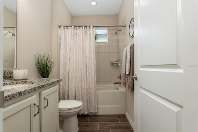 full bathroom with shower / bathtub combination with curtain, vanity, and toilet