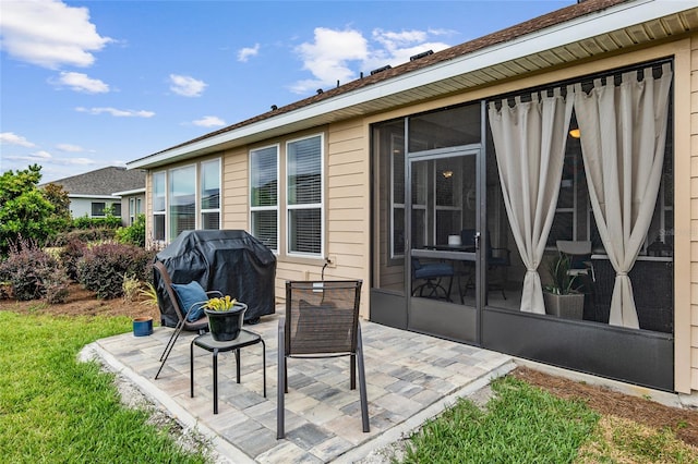 view of patio / terrace with a grill and a sunroom