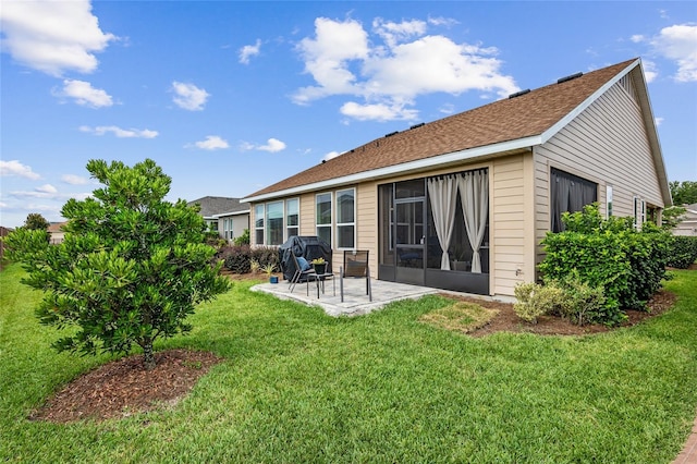 back of property with a patio area and a lawn