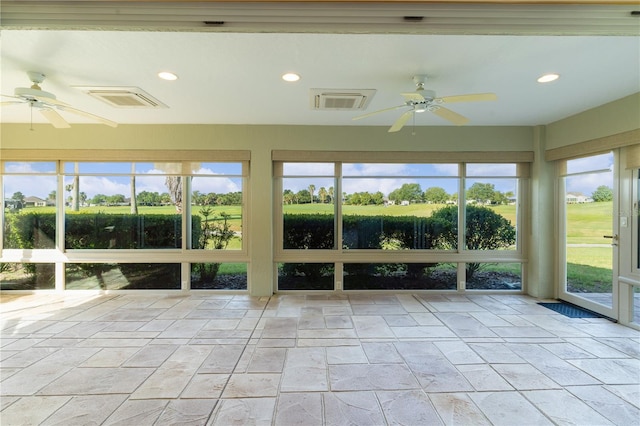 unfurnished sunroom with ceiling fan