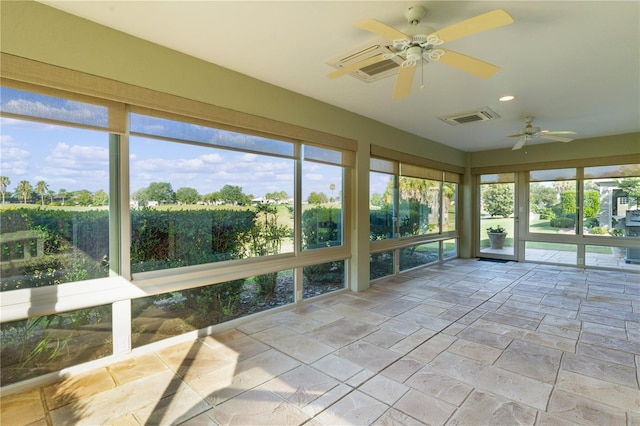 unfurnished sunroom featuring plenty of natural light and ceiling fan