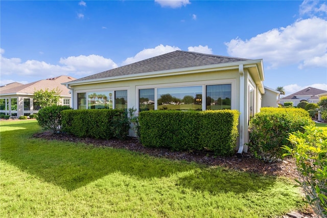 view of side of property with a yard