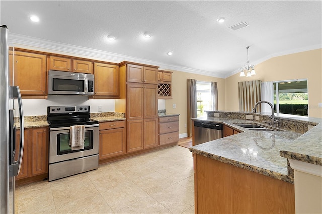 kitchen with lofted ceiling, sink, appliances with stainless steel finishes, decorative light fixtures, and a chandelier