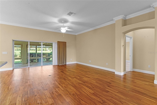 spare room with hardwood / wood-style flooring, ceiling fan, and ornamental molding