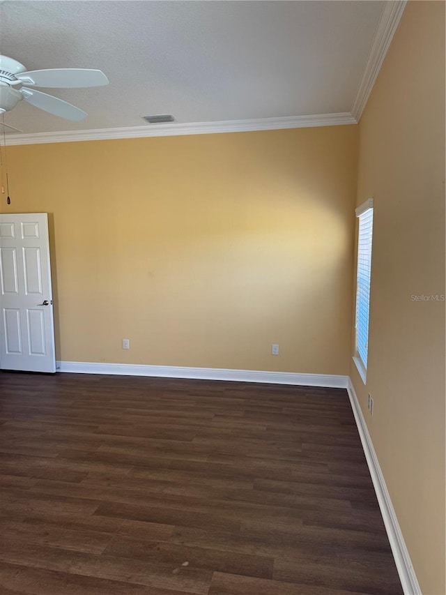 empty room featuring crown molding, ceiling fan, and dark hardwood / wood-style floors