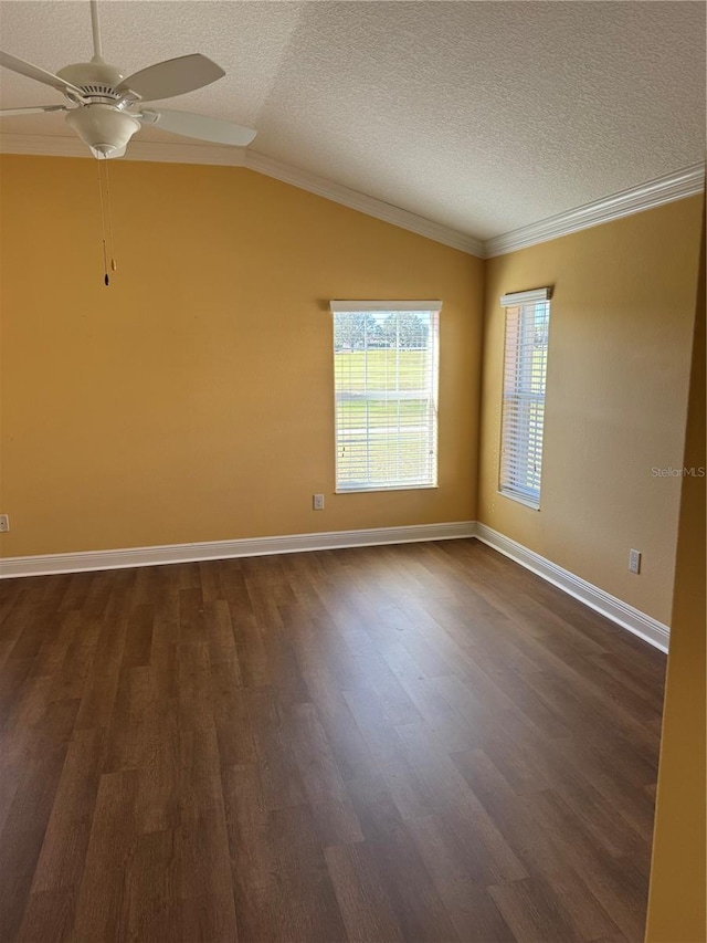 unfurnished room featuring ceiling fan, dark hardwood / wood-style flooring, crown molding, a textured ceiling, and lofted ceiling