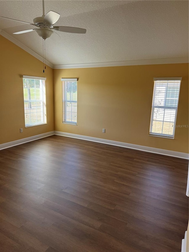 spare room featuring ceiling fan, crown molding, dark hardwood / wood-style floors, and lofted ceiling