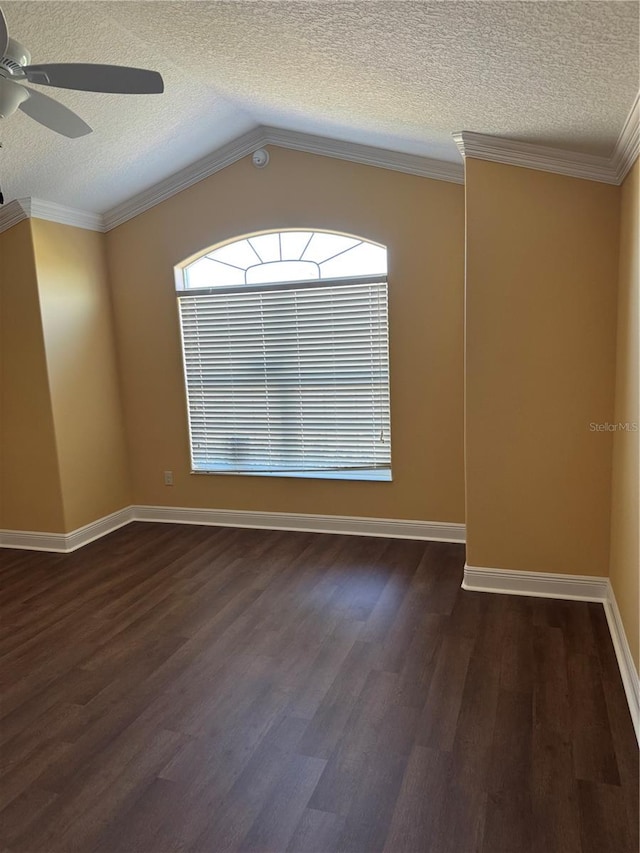 unfurnished room featuring a textured ceiling, ceiling fan, dark wood-type flooring, and vaulted ceiling