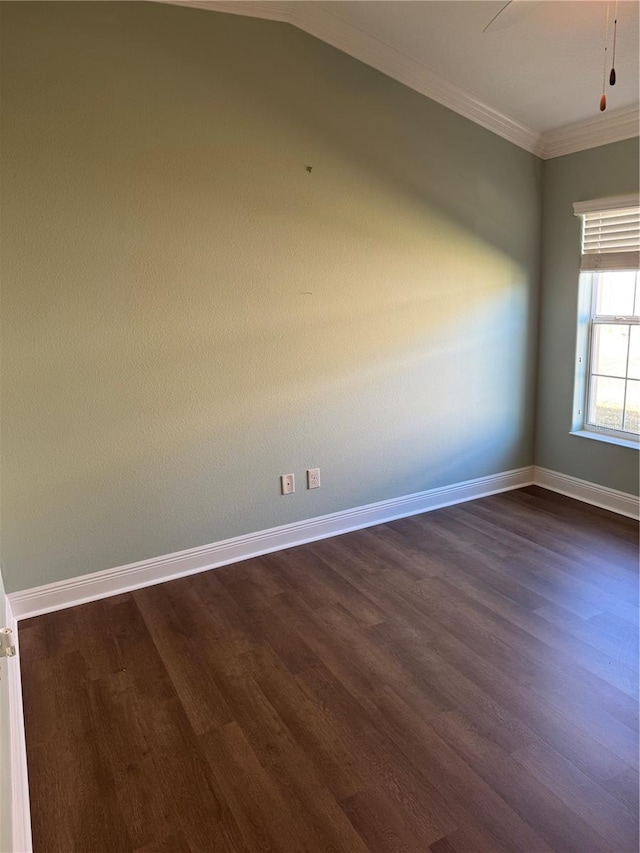 empty room featuring dark hardwood / wood-style flooring, vaulted ceiling, ceiling fan, and crown molding