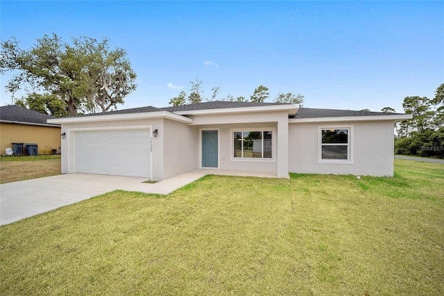 single story home featuring a garage and a front lawn