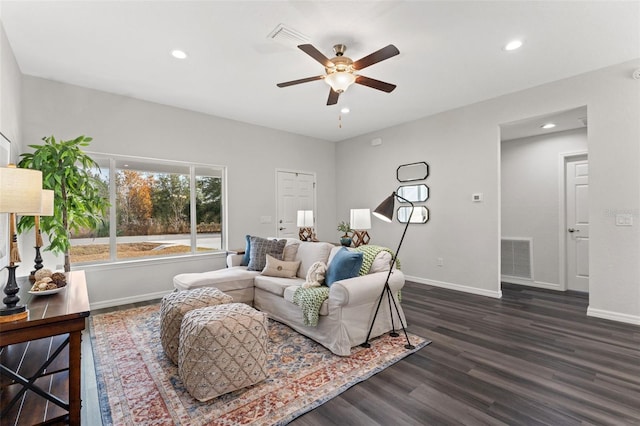 living room with ceiling fan and dark hardwood / wood-style flooring