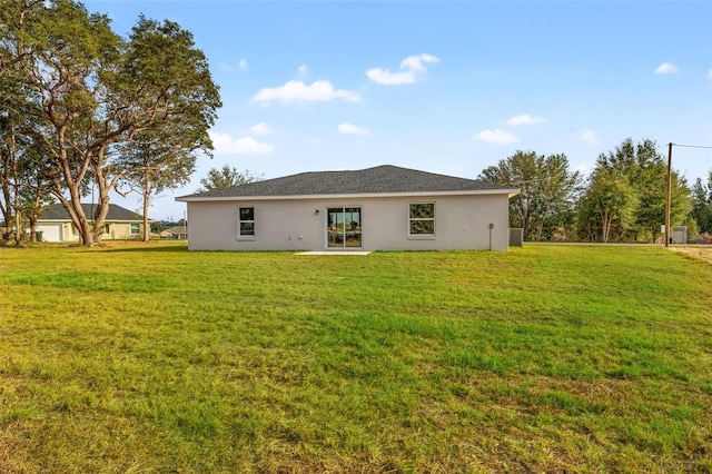 rear view of house with a lawn