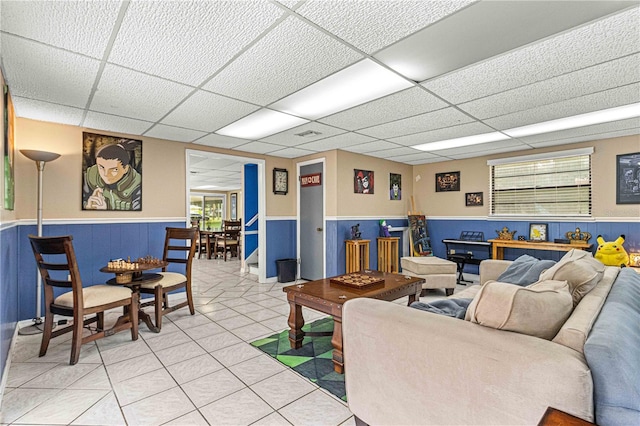 tiled living room with a paneled ceiling