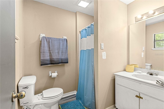 bathroom featuring walk in shower, vanity, and toilet