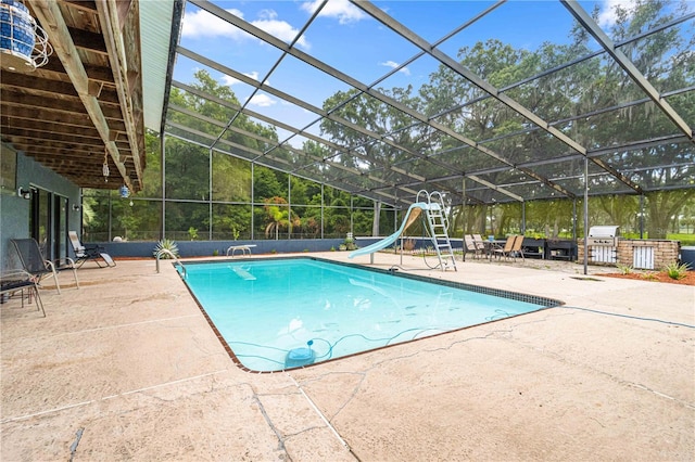 view of pool with a patio, a lanai, and a water slide