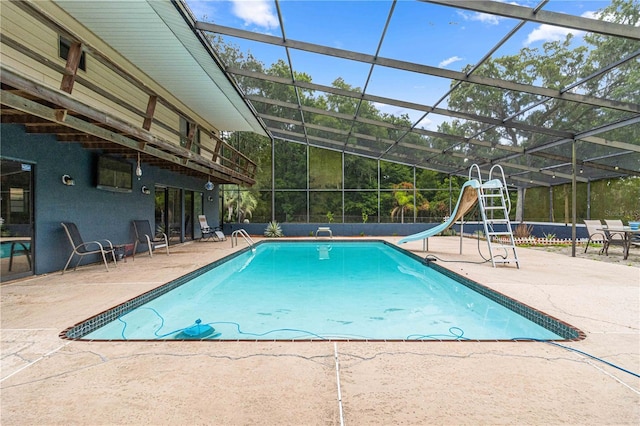 view of swimming pool with a patio, a lanai, and a water slide