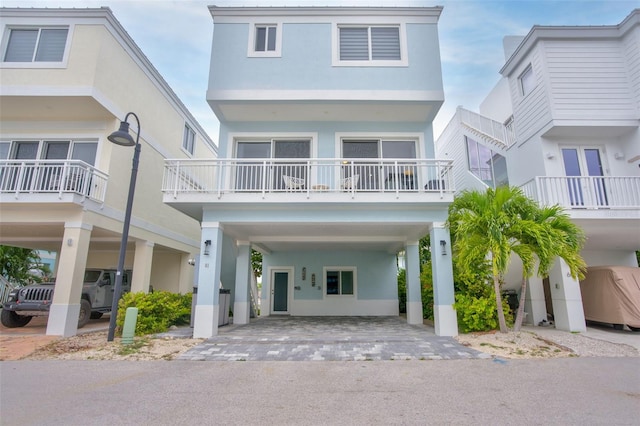 view of front of home featuring a carport and a balcony