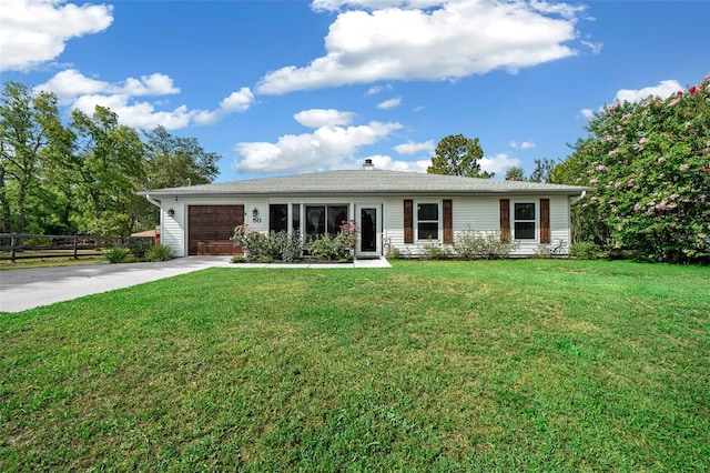 ranch-style home with a front lawn and a garage