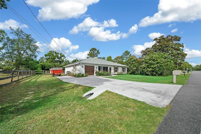 view of front of house with a front yard and a garage