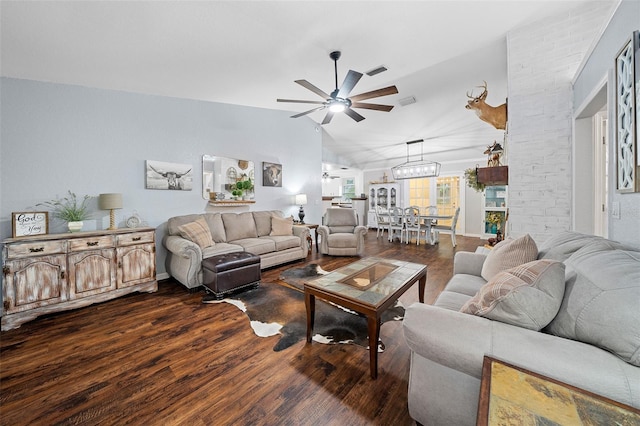 living room with dark hardwood / wood-style floors, lofted ceiling, and ceiling fan with notable chandelier