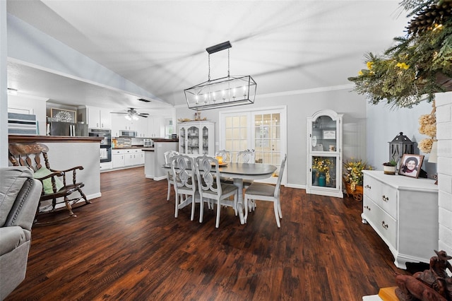 dining area with ceiling fan, dark hardwood / wood-style flooring, crown molding, and lofted ceiling