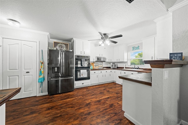 kitchen featuring appliances with stainless steel finishes, backsplash, sink, dark hardwood / wood-style floors, and white cabinetry